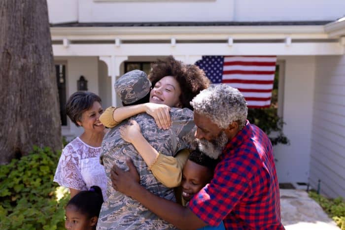 family hugging military