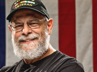 veteran with american flag background 